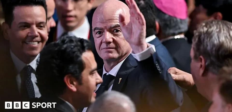 Man waving at event surrounded by attendees