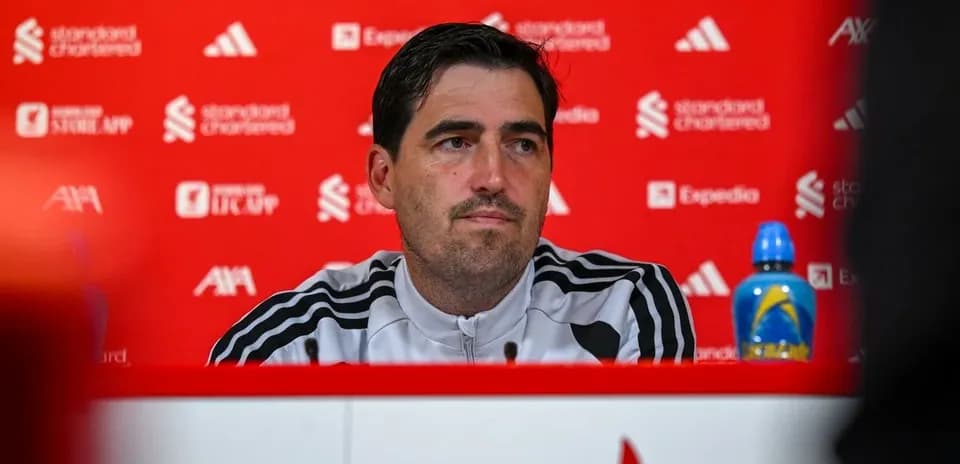 Manager at press conference with red background