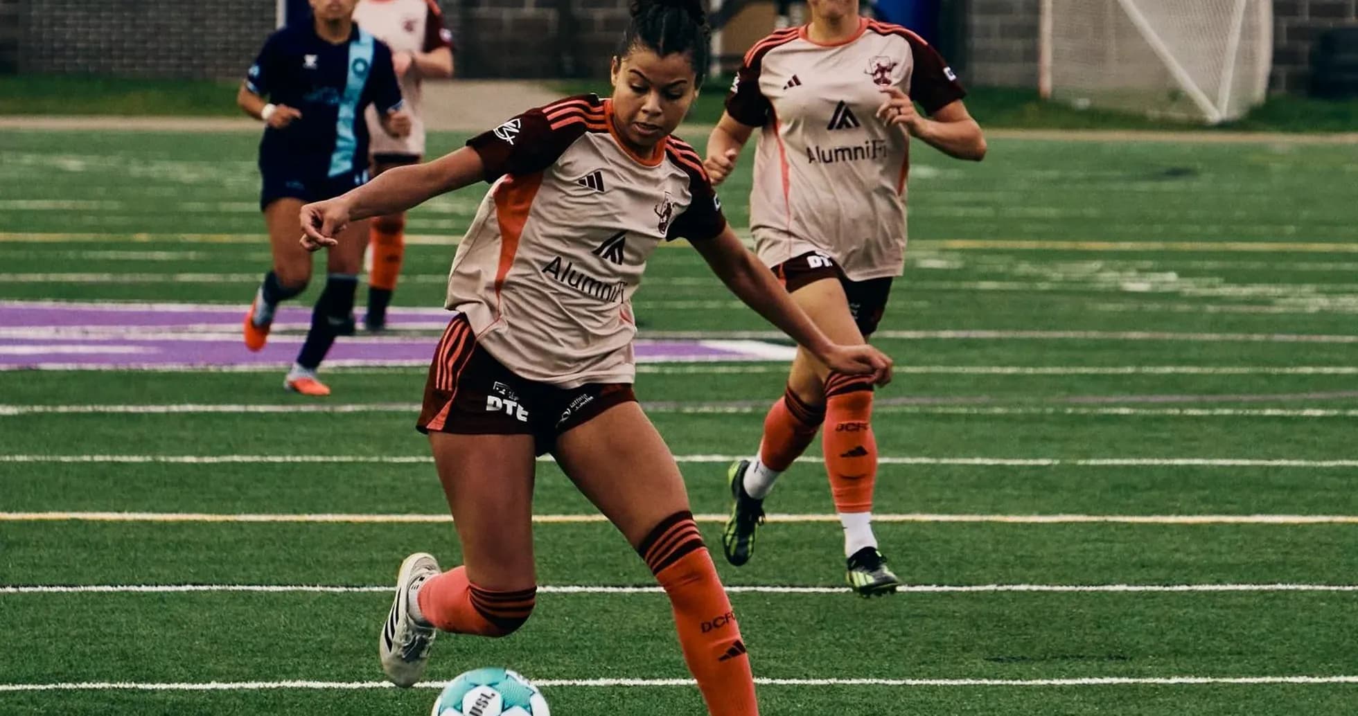 Player dribbling the ball during Detroit City match