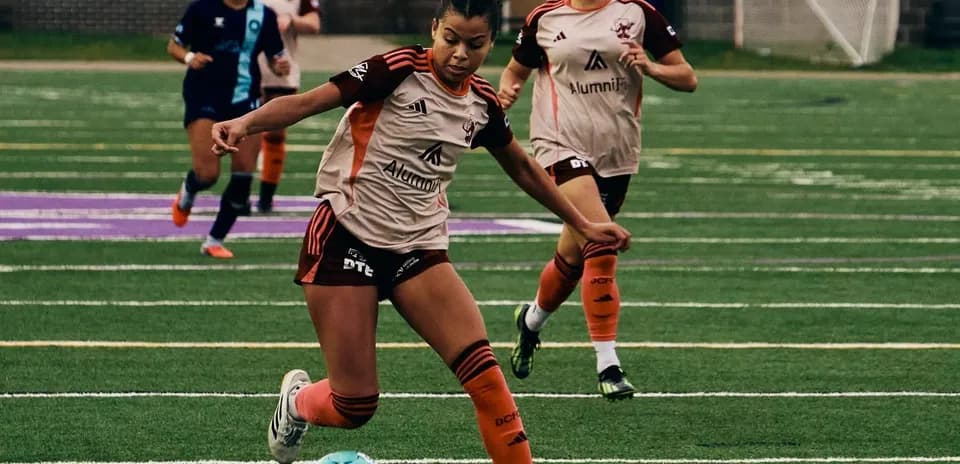 Player dribbling the ball during Detroit City match
