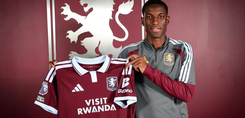 Player holding Aston Villa jersey during presentation