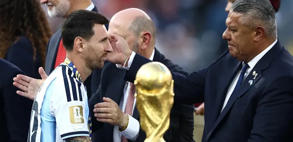 Lionel Messi receiving trophy after winning World Cup