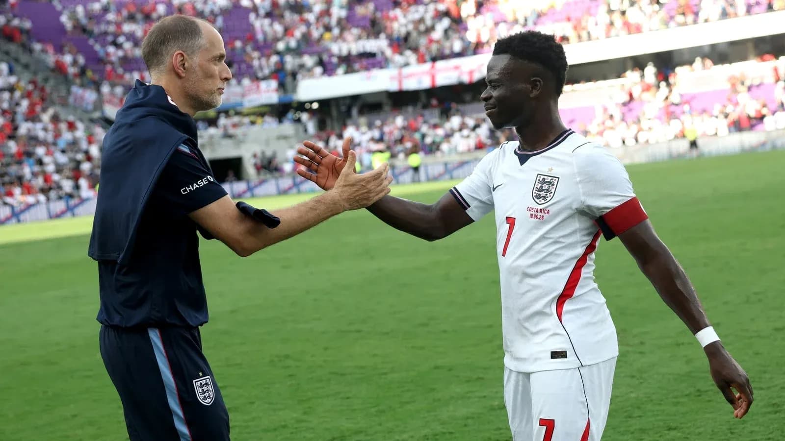 Coach and player shaking hands after the match