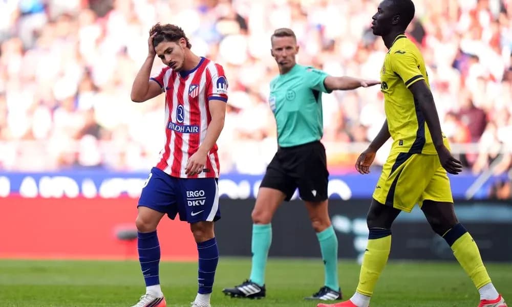 Atletico Madrid player reacting during match with referee