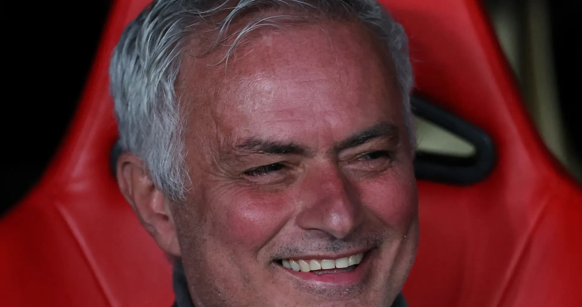 Coach smiling while seated on the bench