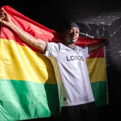 Player holding a flag with yellow and green stripes