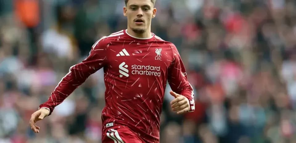 Player running in Liverpool FC kit during match