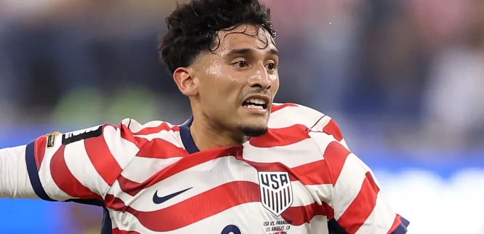 Player in red and white striped USA jersey during match