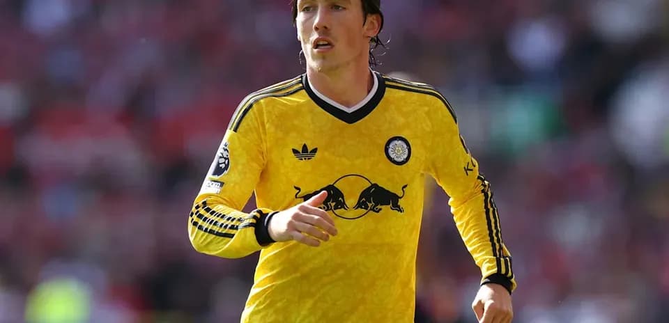 Player running on field in yellow jersey