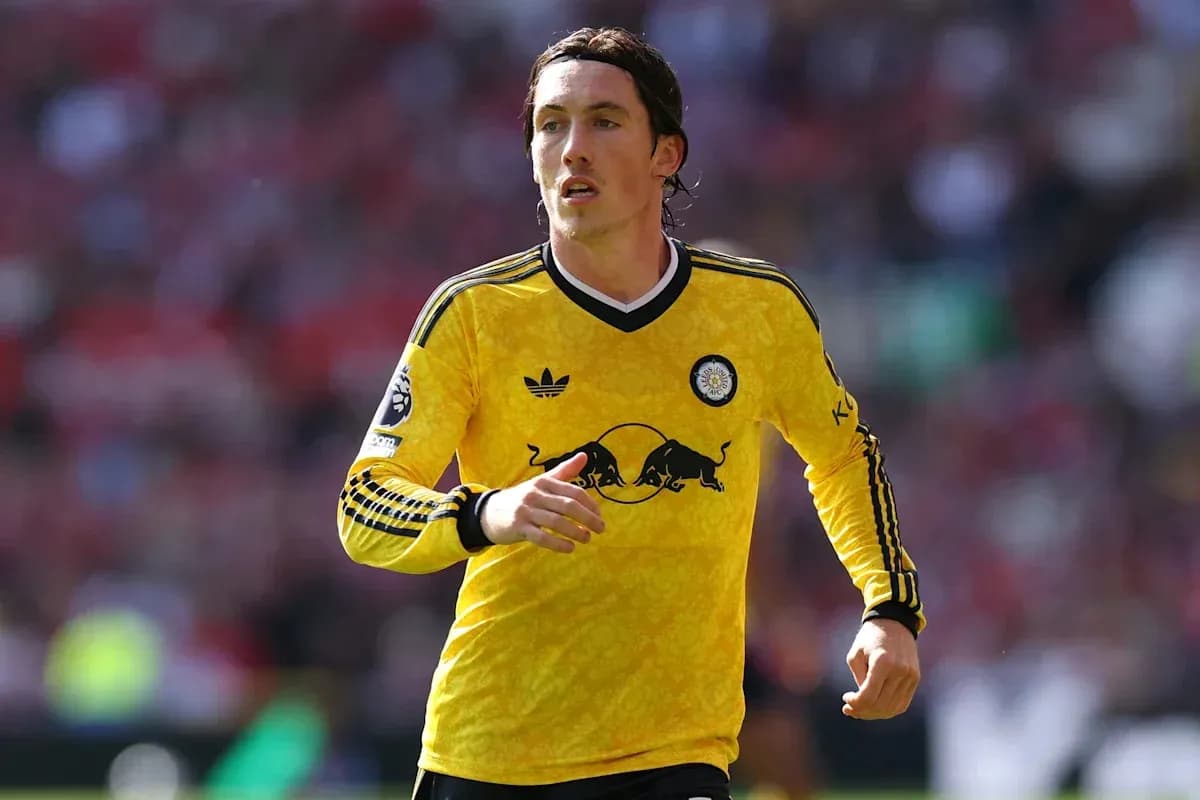 Player running on field in yellow jersey