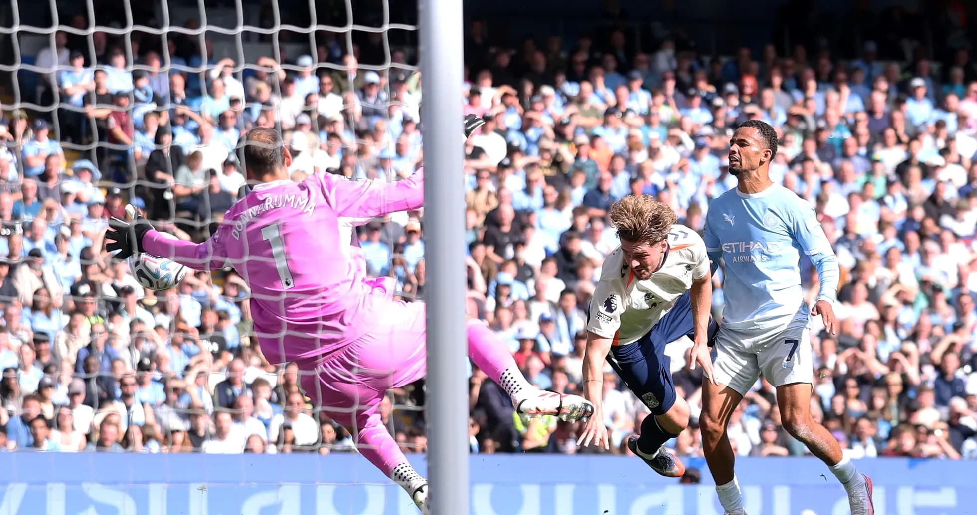 Goalkeeper attempting to save shot on goal