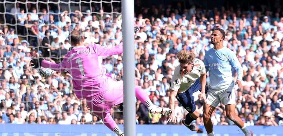 Goalkeeper attempting to save shot on goal