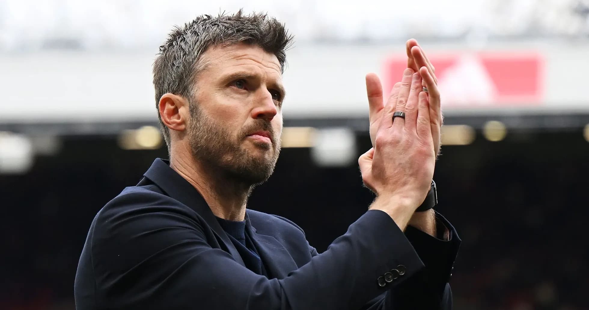 Coach applauding fans during a match