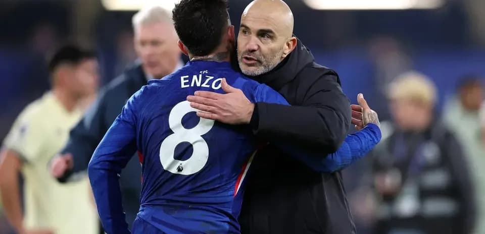 Coach embracing player Enzo after the match