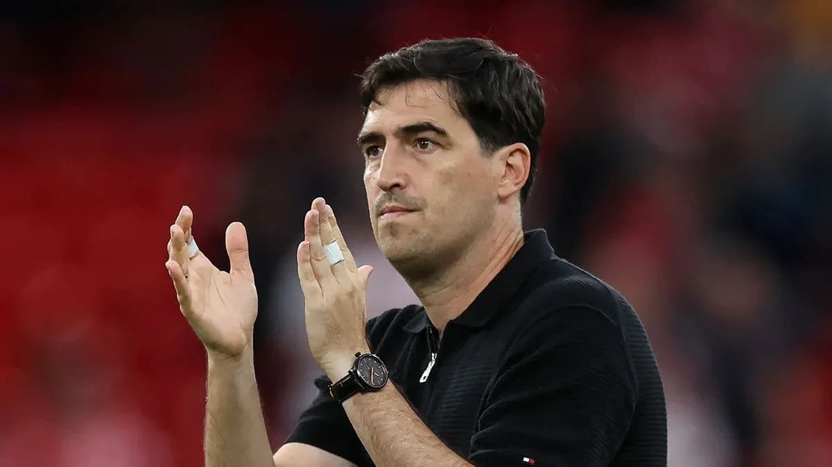 Coach applauding in front of a cheering crowd