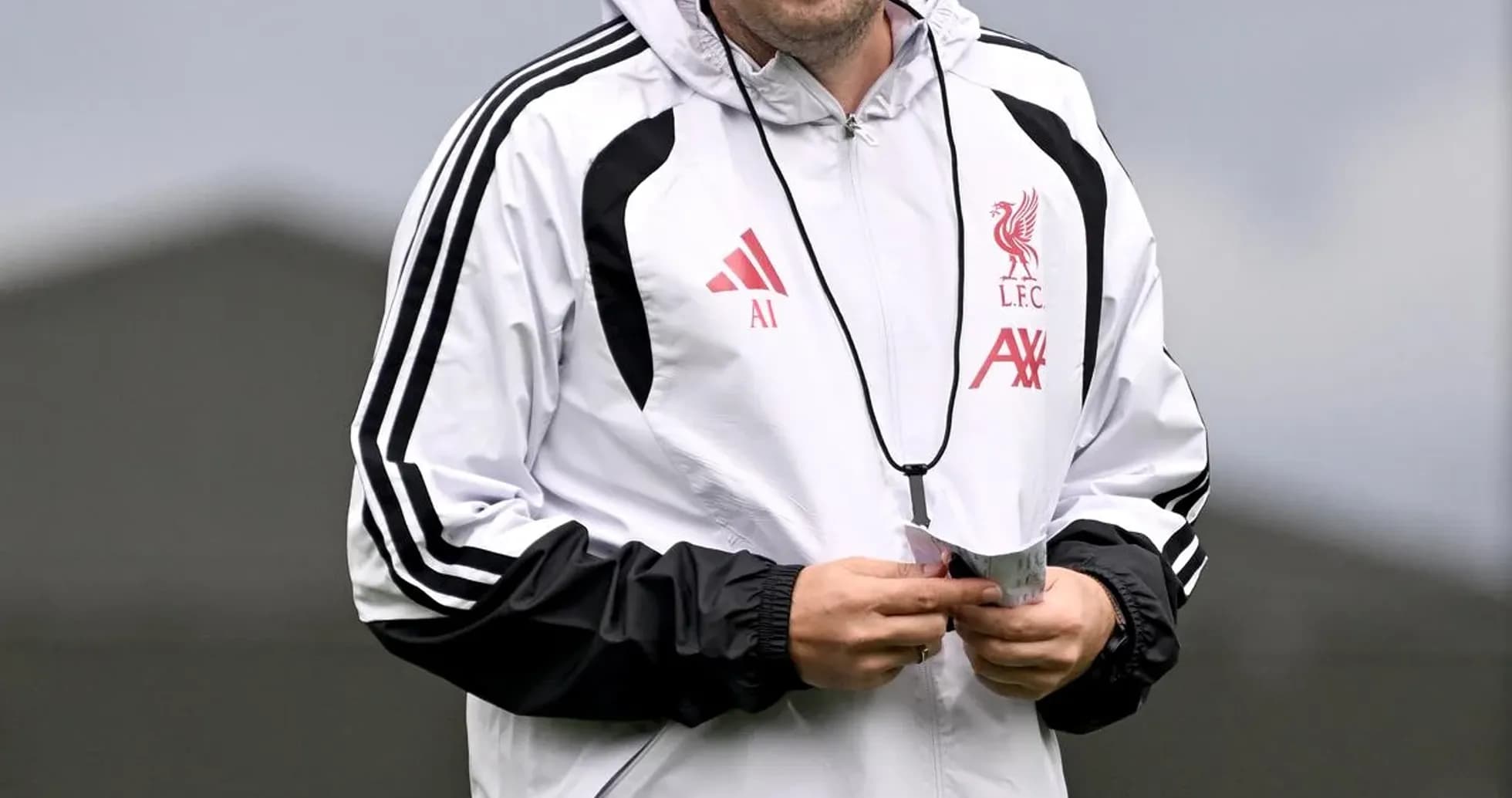 Coach walking during training session at Liverpool FC