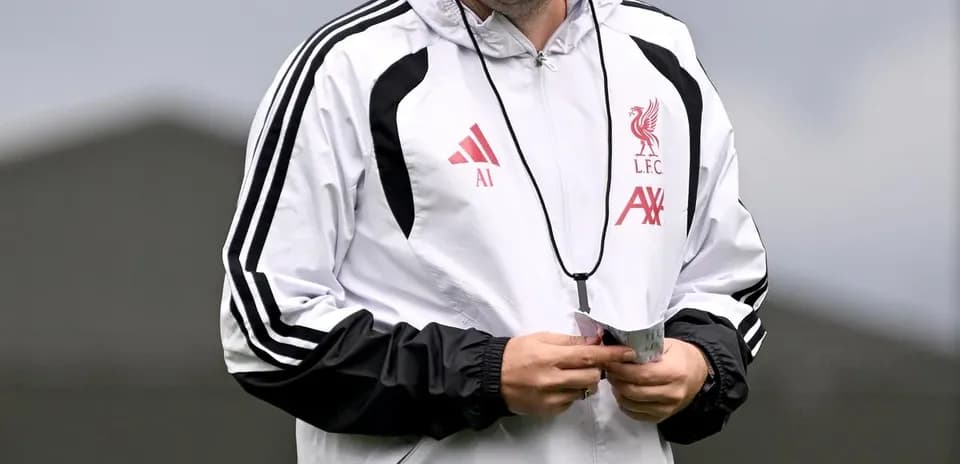 Coach walking during training session at Liverpool FC