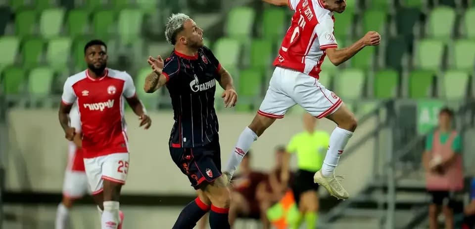 FK Crvena Zvezda player challenging for the ball
