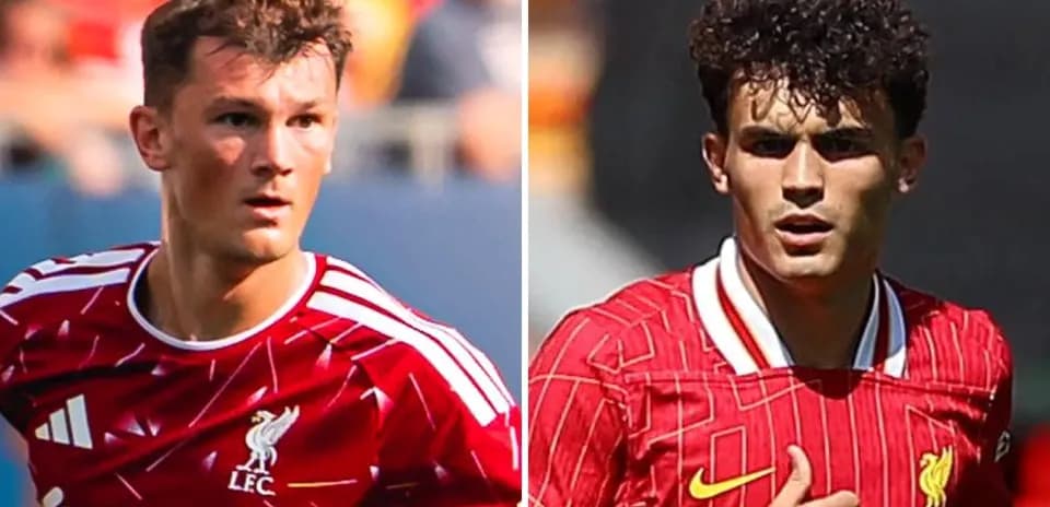 Two Liverpool players in red kits on field