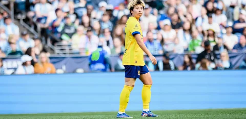 Player in yellow jersey during NWSL match