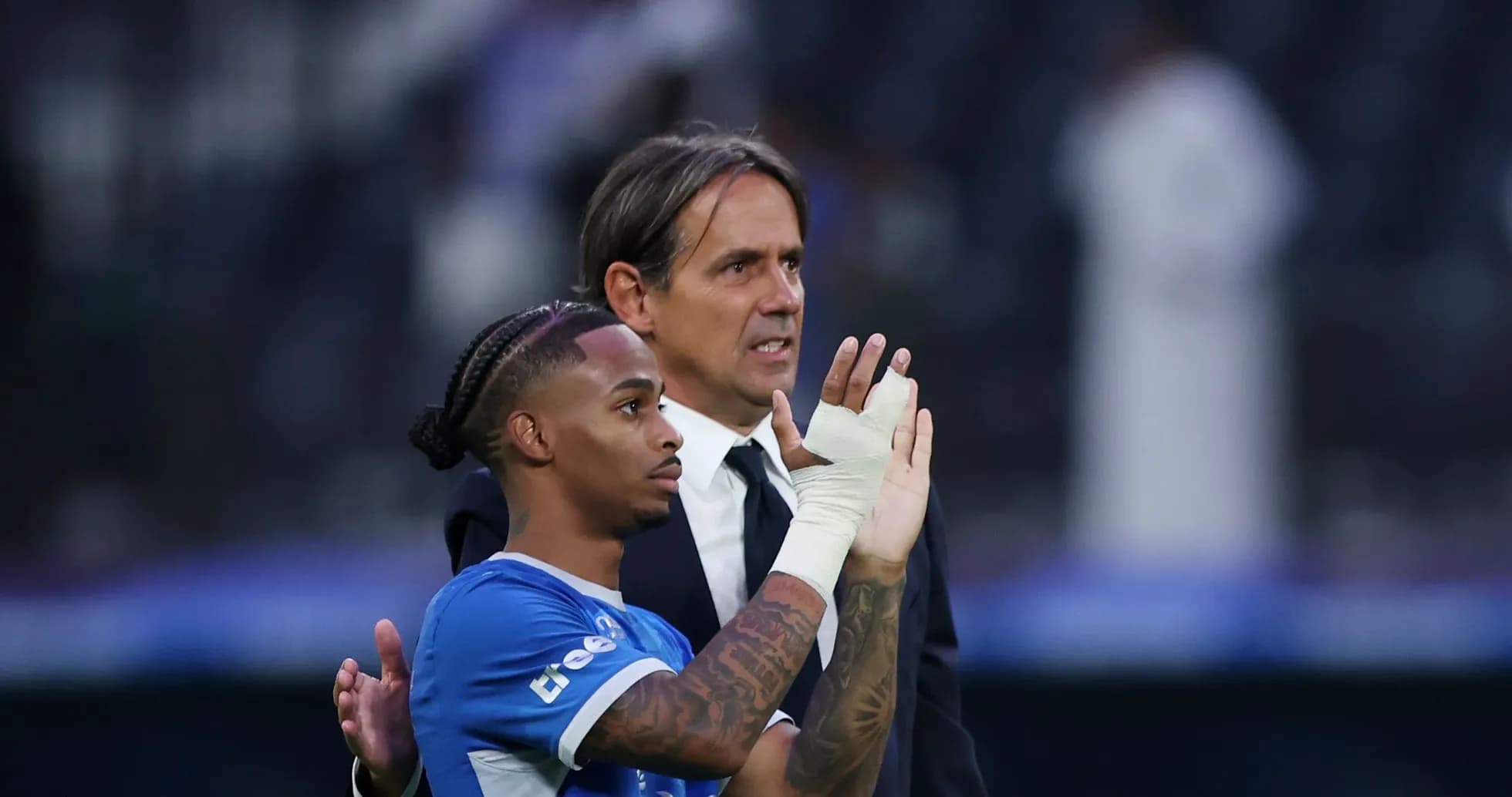 Player and coach acknowledging the crowd after match