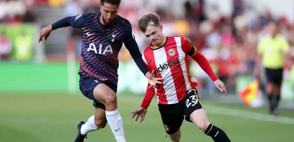 Brentford player challenging Tottenham opponent for ball