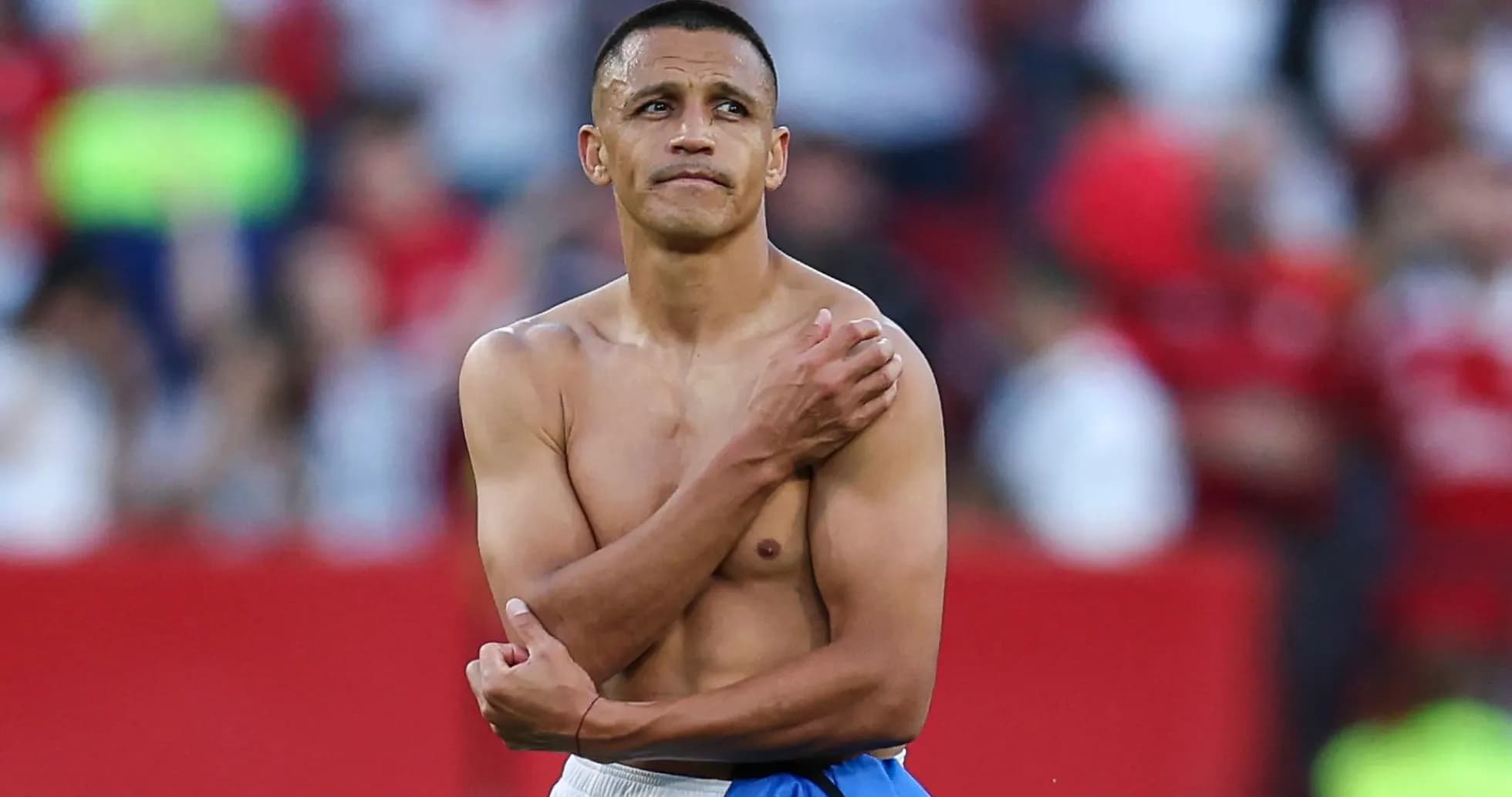 Player with bare torso on the field after match