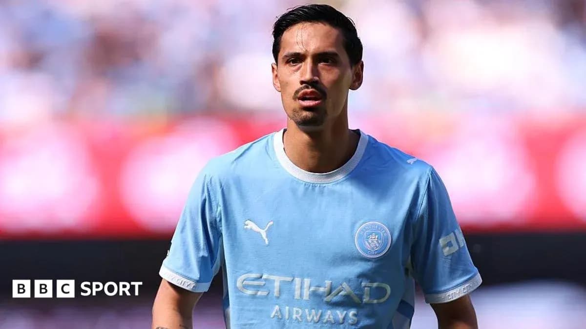 Player in light blue jersey on the pitch