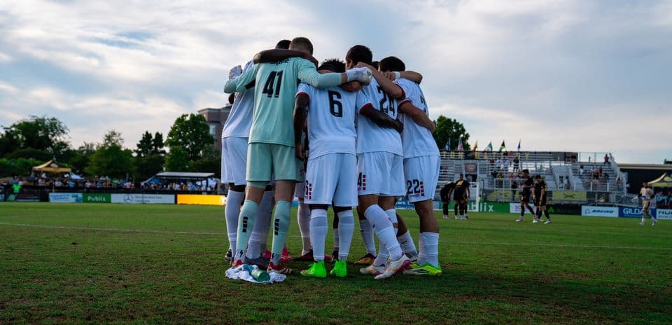 Players huddling before the match