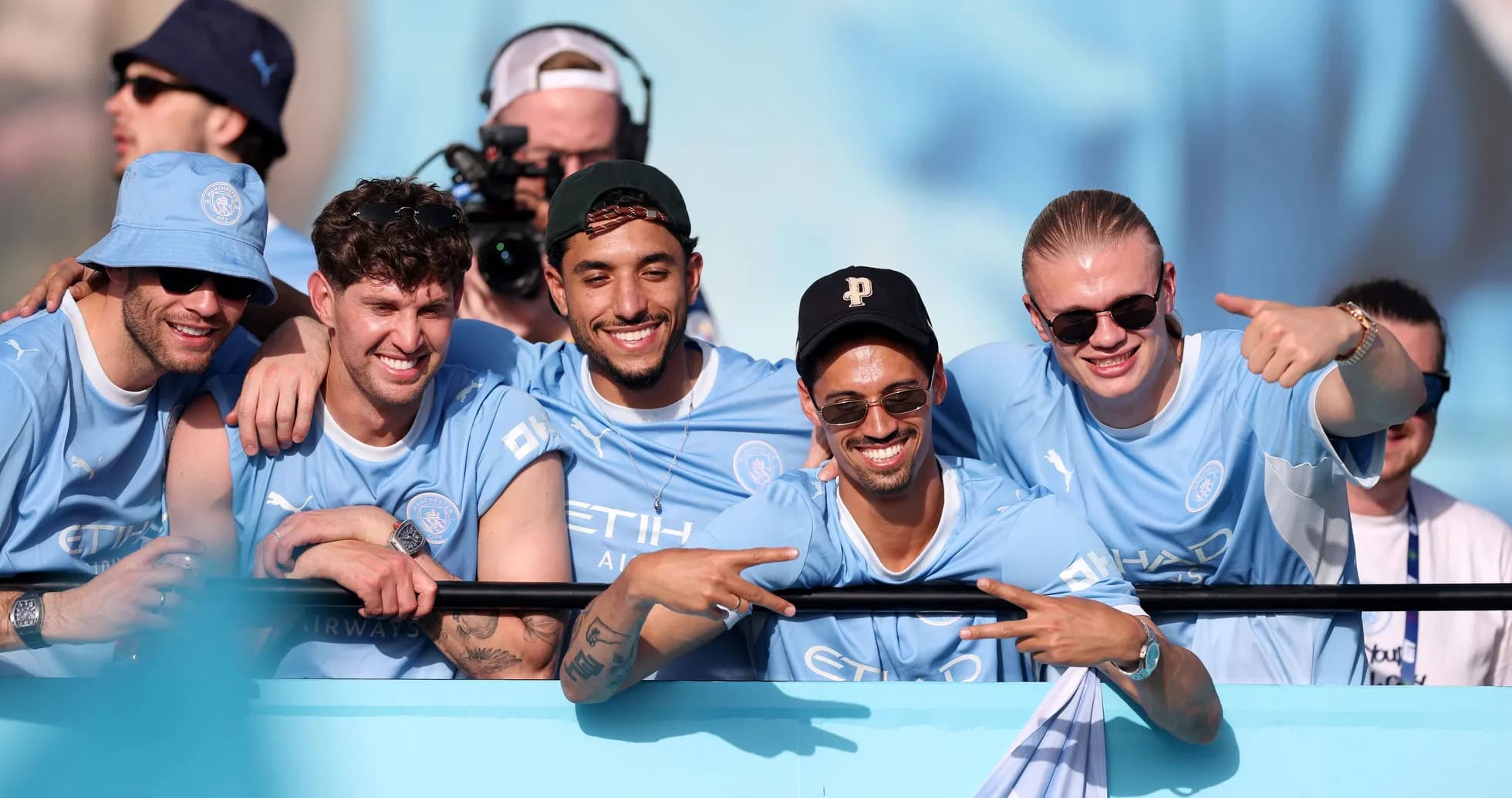 Group of fans celebrating in Manchester City jerseys