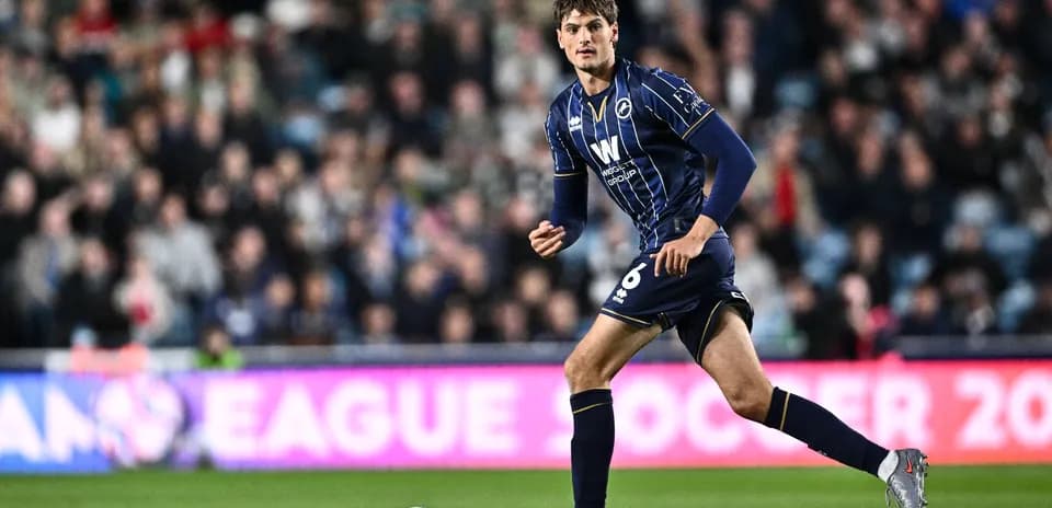 Player in blue kit running on the field