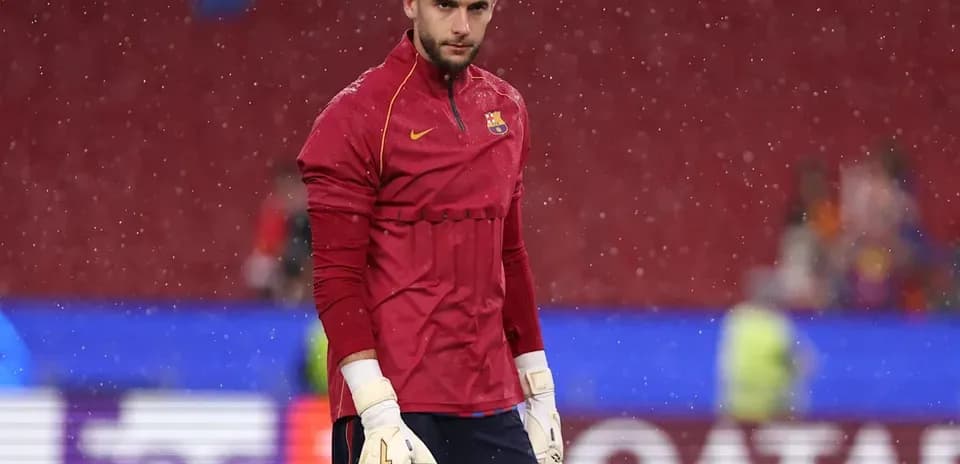 Goalkeeper warming up in rain before match