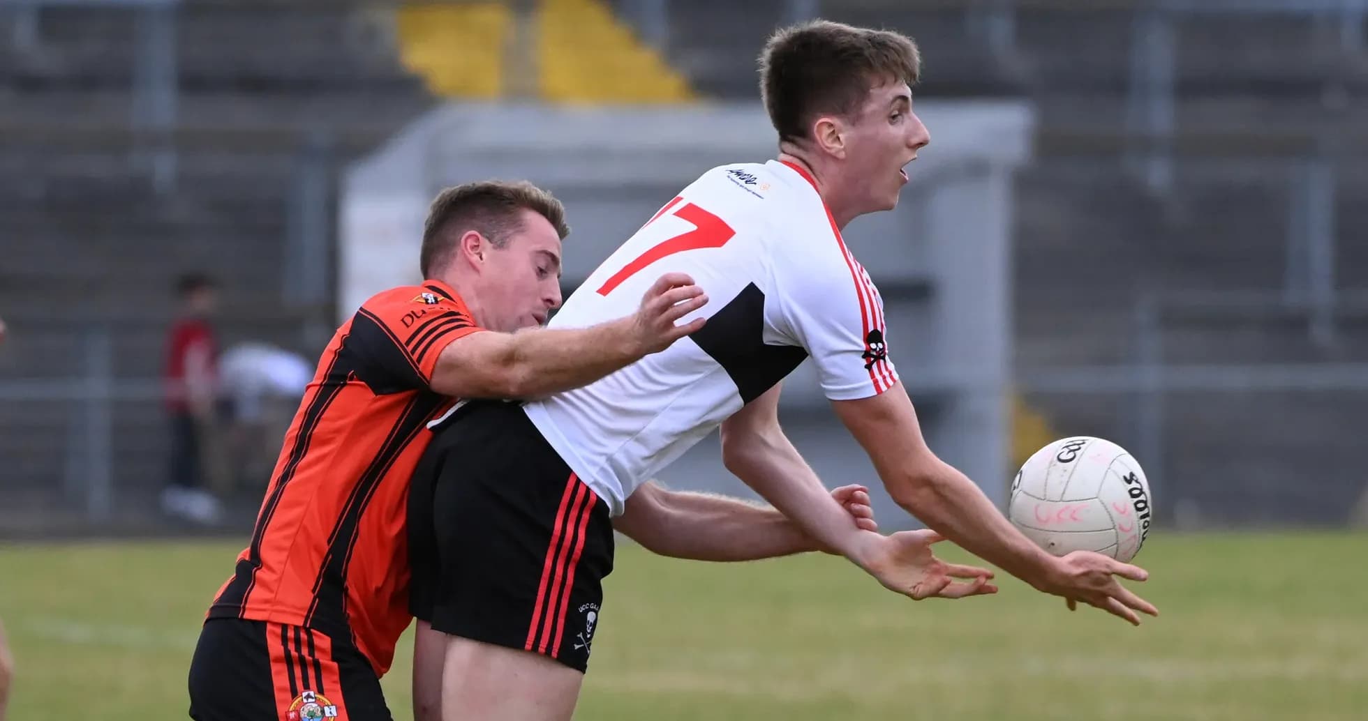 Player in red jersey tackling opponent for the ball