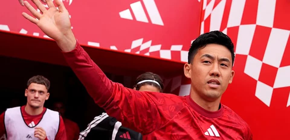 Player waving while entering the stadium tunnel
