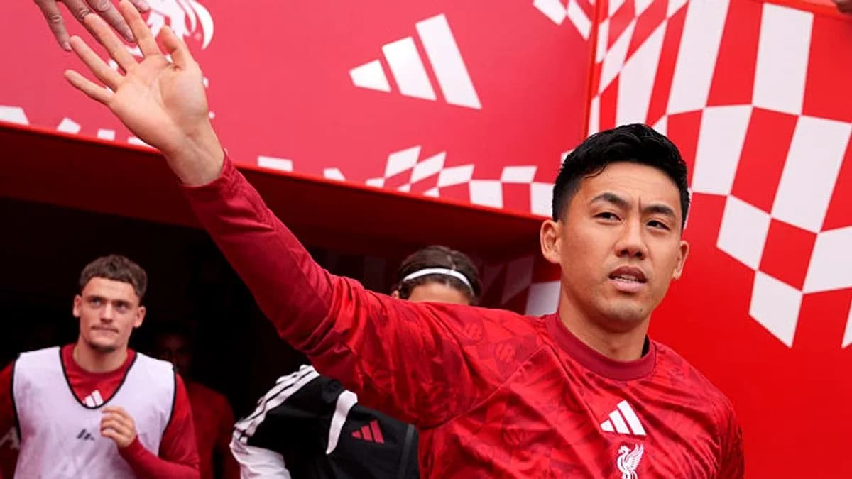 Player waving while entering the stadium tunnel