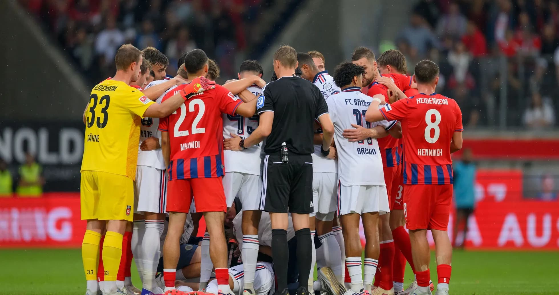 Players from both teams huddled during match
