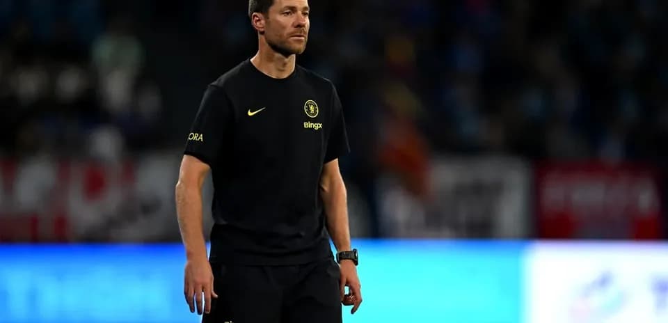 Coach walking on the pitch during match