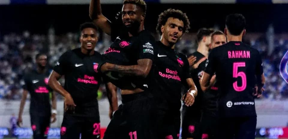 Players celebrating a goal during a football match