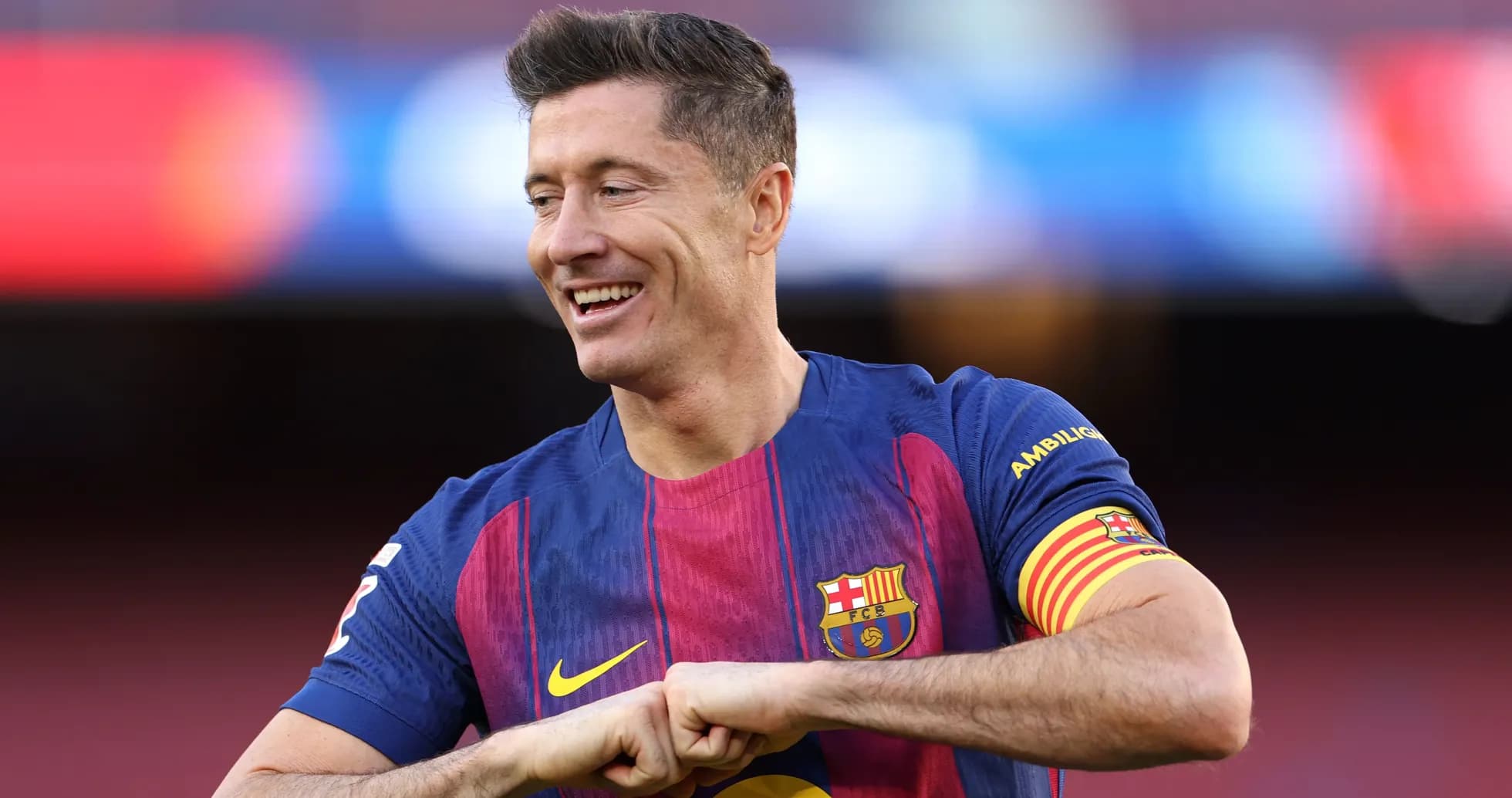 Player in FC Barcelona jersey smiling on field