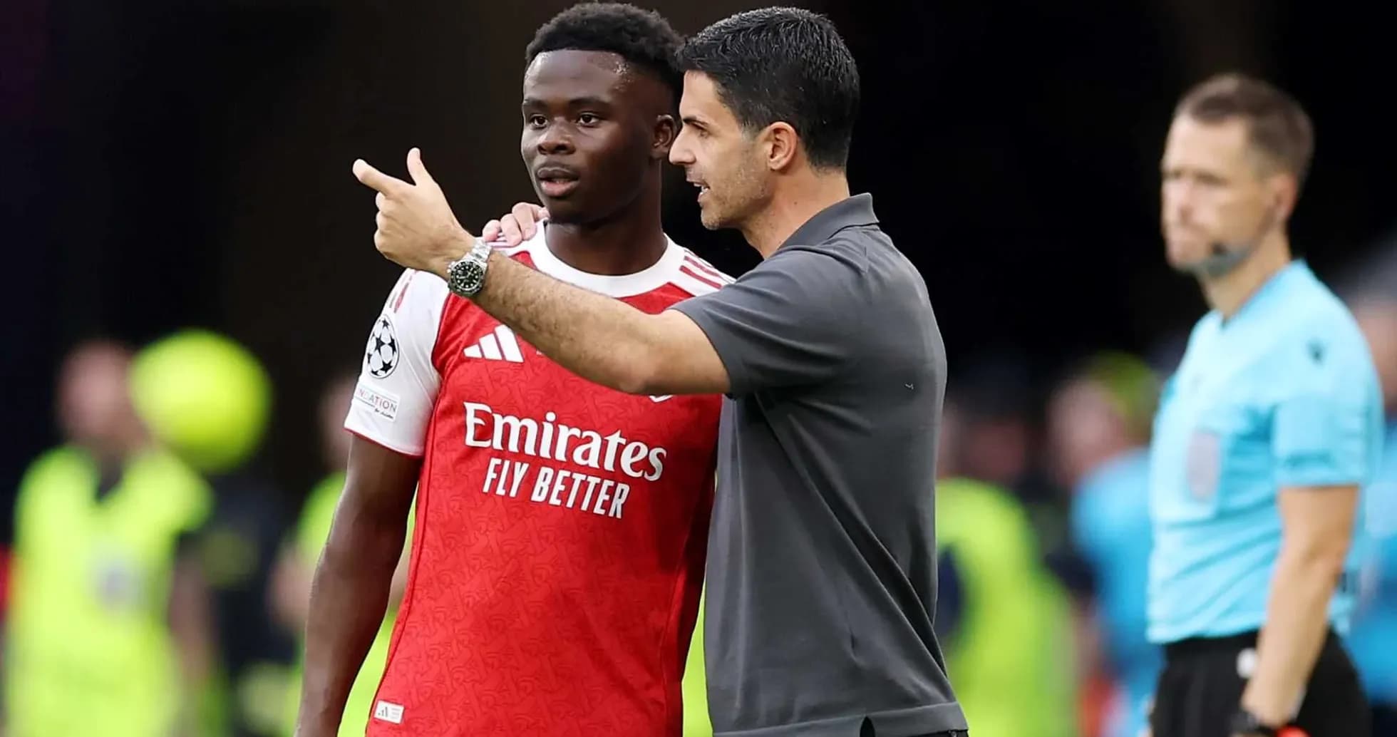Manager discussing strategy with player on sidelines