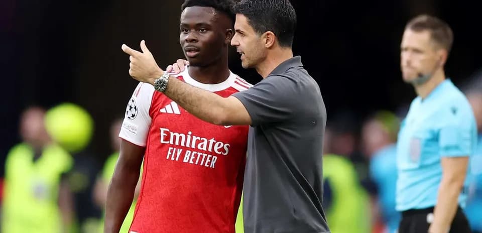 Manager discussing strategy with player on sidelines
