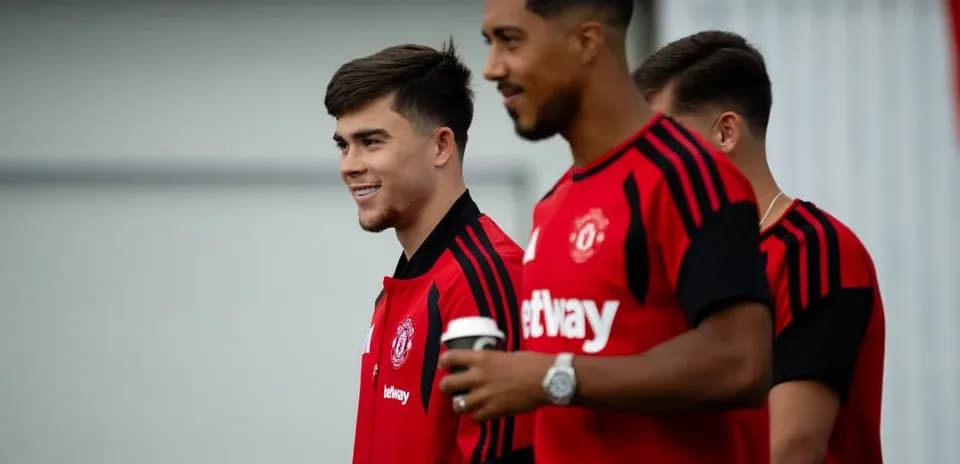 Players in Manchester United training kits smiling together