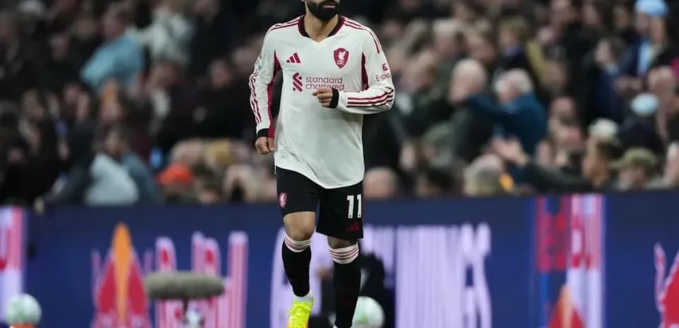 Player wearing Liverpool kit running on the pitch