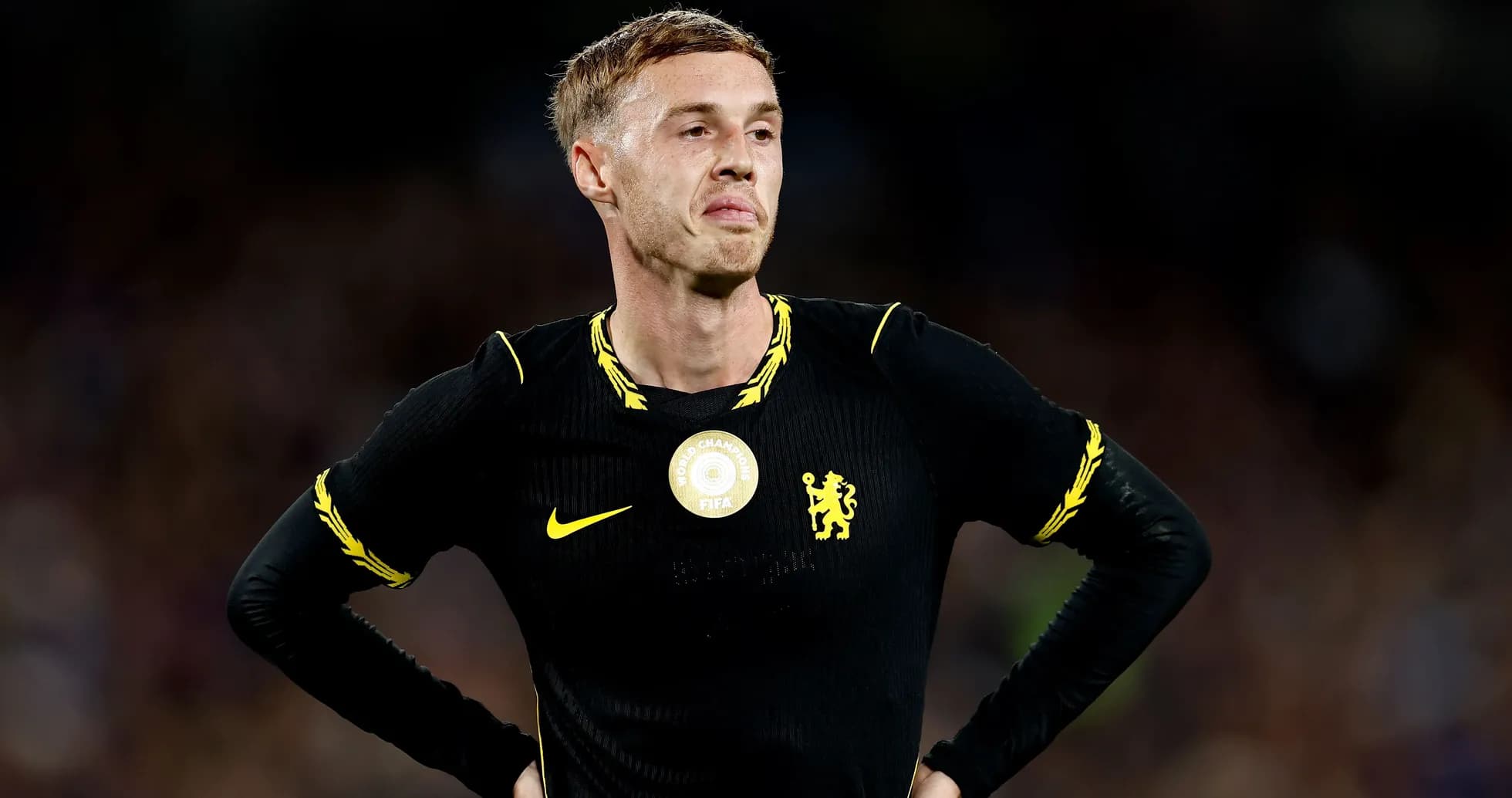 Player in black jersey during match, looking disappointed