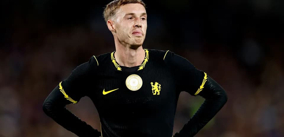 Player in black jersey during match, looking disappointed