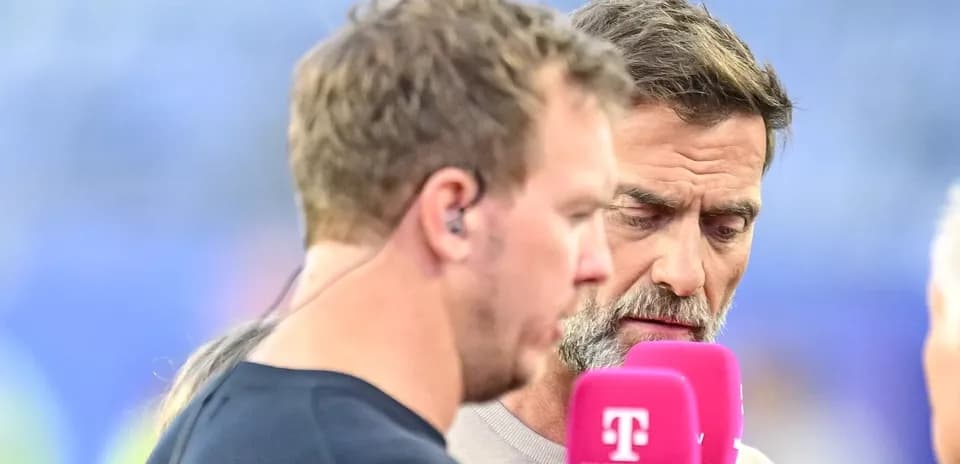 Two men discussing at a broadcast interview setup