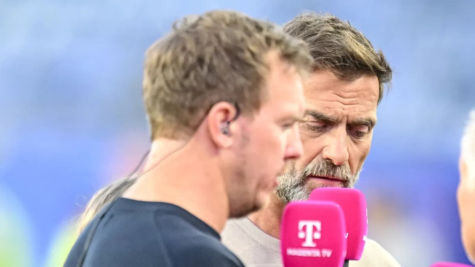 Two men discussing at a broadcast interview setup