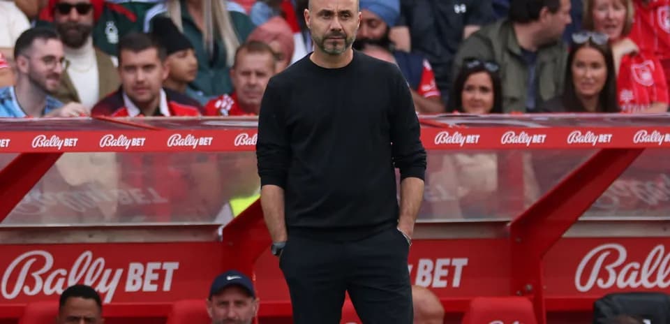 Coach observing the match from the sidelines