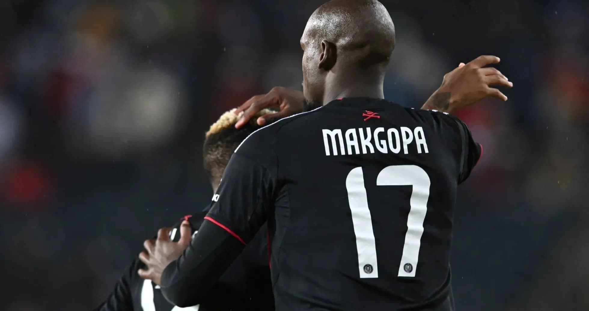 Players celebrating a goal during a match