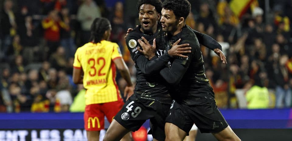 Two PSG players celebrating a goal on field